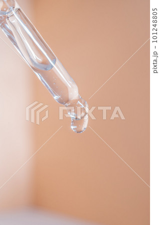 A drop of cosmetic oil falls from the pipette 101248805