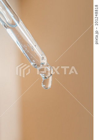 A drop of cosmetic oil falls from the pipette A drop of cosmetic oil falls from the pipette 101248818