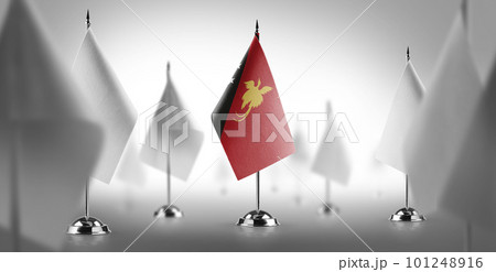 The national flag of the Papua New Guinea surrounded by white flags The national flag of the Papua New Guinea surrounded by white flags 101248916