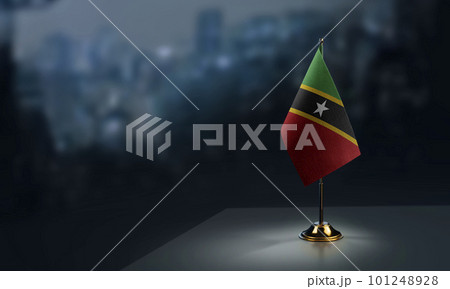 Small flags of the Saint Kitts and Nevis on an abstract blurry background 101248928