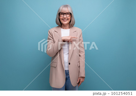 60s middle-aged woman in a stylish laconic jacket on a studio background with copy space 101254051