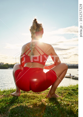 Young woman doing innovative animal flow movement outdoors, training animal flow at sunset Young woman doing innovative animal flow movement outdoors, training animal flow at sunset 101257329
