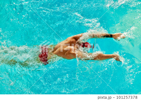 Aerial Top View Male Swimmer Swimming in Swimming Pool. Professional Athlete Training for the Championship, using Front Crawl, Freestyle Technique. Top View Shot 101257378