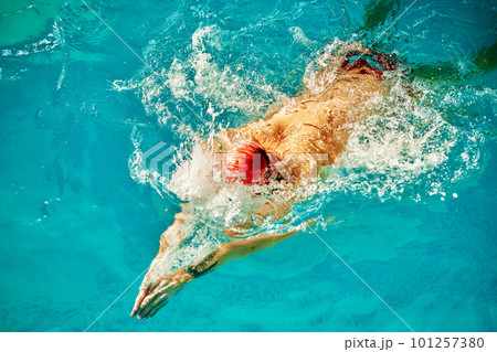 Aerial Top View Male Swimmer Swimming in Swimming Pool. Professional Athlete Training for the Championship, using Front Crawl, Freestyle Technique. Top View Shot 101257380