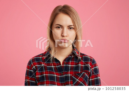 Attractive abused female model curves lips as being offended by close person, expresses her dissatisfaction, isolated over pink background. Depressed beautiful woman with dipleased expression Attractive abused female model curves lips as being offended by close person, expresses her dissatisfaction, isolated over pink background. Depressed beautiful woman with dipleased expression 101258035