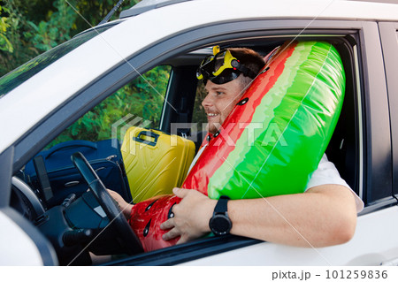 sea vacation car travel concept man in scuba mask driving car full of bags sea vacation car travel concept man in scuba mask driving car full of bags 101259836