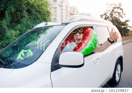 sea vacation car travel concept man in scuba mask driving car full of bags sea vacation car travel concept man in scuba mask driving car full of bags 101259837