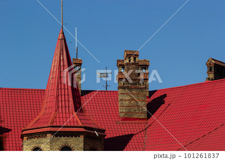 Red house roof with red brick chimney. Ceramic chimney, metal roof tiles, gutters 101261837