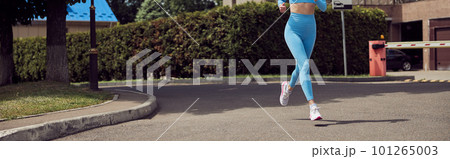 Beautiful fit young woman jogger is running outdoors Beautiful fit young woman jogger is running outdoors 101265003