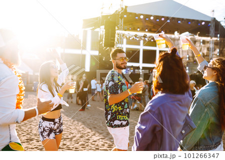Group of friends with beer dancing and having fun at music festival together. Summer Beach party. Group of friends with beer dancing and having fun at music festival together. Summer Beach party. 101266347