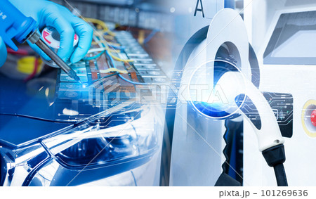Electric vehicle charging station for charge EV battery and technician soldering metal of EV car lithium-ion rechargeable battery in factory. Commercial EV charging point business. Li-ion battery. 101269636