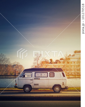 Old van parked on the edge of the street in the sunset sky background, Asnieres sur Seine, Paris suburb, France Old van parked on the edge of the street in the sunset sky background, Asnieres sur Seine, Paris suburb, France 101270518