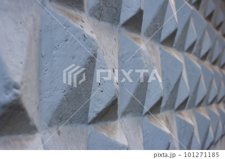 Abstract grunge background. Concrete faceted geometric figures of a pyramid extending into the distance. 101271185