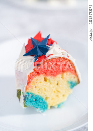 Slice of July 4th bundt cake covered with a vanilla glaze and decorated with chocolate stars. Slice of July 4th bundt cake covered with a vanilla glaze and decorated with chocolate stars. 101273075
