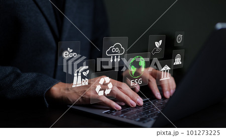 Businessman use a computer to analyze ESG data. icons pop up on virtual screen in business sustainability investment strategy concept. ESG environmental social governance investment business concept. 101273225