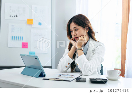 Businesswoman in suit is reading business data for thinking and Businesswoman in suit is reading business data for thinking and 101273418