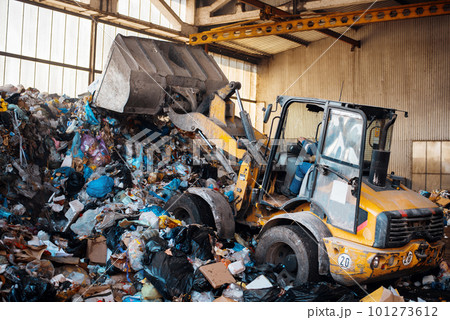 An excavator working at waste sorting plant An excavator working at waste sorting plant 101273612