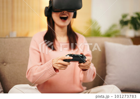 Young woman lesbian wearing sweater and VR goggles while holding 101273783