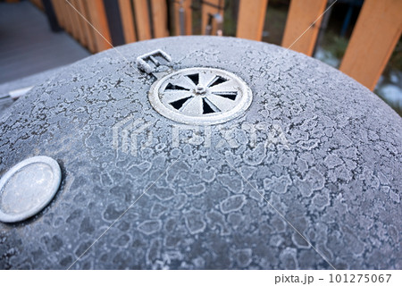 A close up of a bbq grill covered in ice 101275067