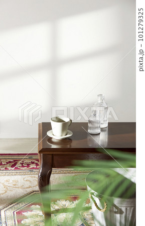A room with a calm atmosphere, with clay pots placed in front of the wall and curtains letting in natural light. Glass bottles, coffee, and various objects on a marble table A room with a calm atmosphere, with clay pots placed in front of the wall and curtains letting in natural light. Glass bottles, coffee, and various objects on a marble table 101279325