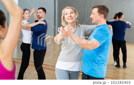 Mature dancing couple during group class Mature dancing couple during group class 101283403