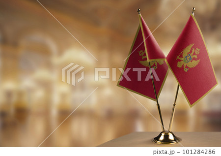 Small flags of the Montenegro on an abstract blurry background Small flags of the Montenegro on an abstract blurry background 101284286