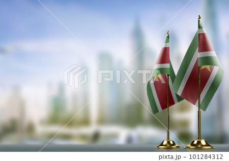 Small flags of the Suriname on an abstract blurry background Small flags of the Suriname on an abstract blurry background 101284312