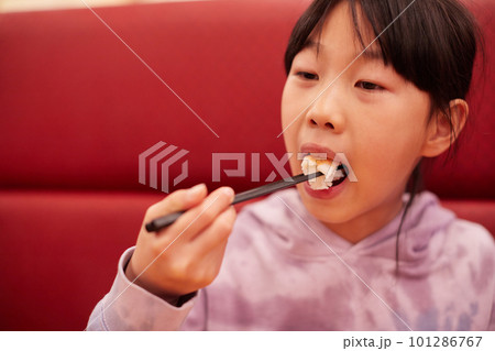 回転寿司の店で海老の寿司を食べる小学生の女の子の様子 回転寿司の店で海老の寿司を食べる小学生の女の子の様子 101286767