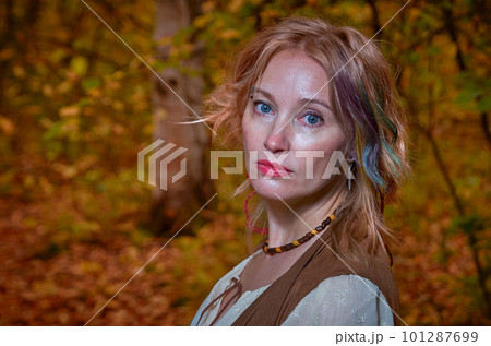 Portrait of a beautiful woman in autumn park 101287699