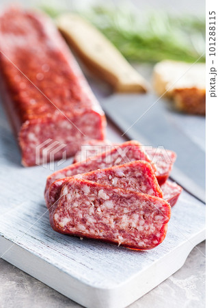 Smoked .sausage. Sliced salami on cutting board. Smoked .sausage. Sliced salami on cutting board. 101288115