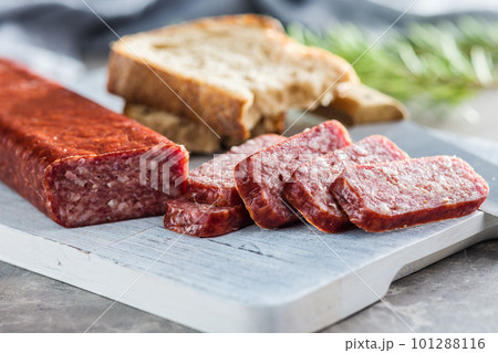 Smoked .sausage. Sliced salami on cutting board. Smoked .sausage. Sliced salami on cutting board. 101288116