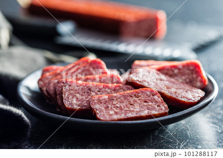 Smoked .sausage. Sliced salami on plate. 101288117