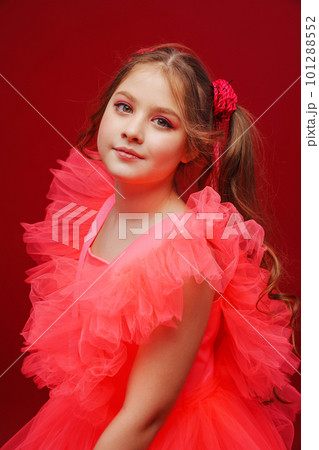 portrait of a beautiful teenage girl with ponytails in a pink elegant dress.  101288552