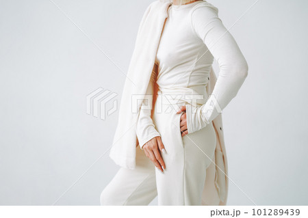 Crop photo of young blonde woman in sportswear on background of white wall 101289439