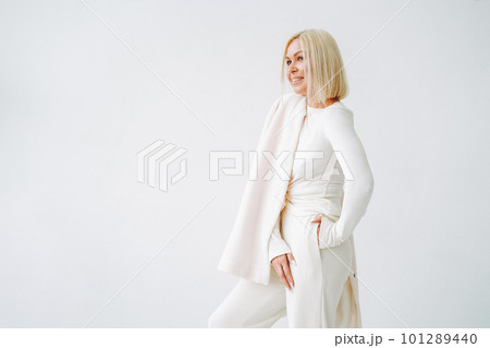 Young blonde woman in sportswear on background of white wall 101289440