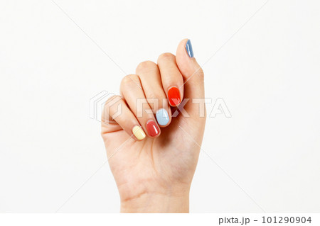 Beautiful female hand painting acrylic gel nails. Fashion style. White background. 101290904
