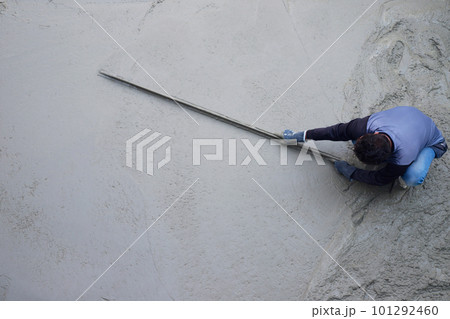 Workers plastering ready mixed concrete floor at the construction agency Workers plastering ready mixed concrete floor at the construction agency 101292460
