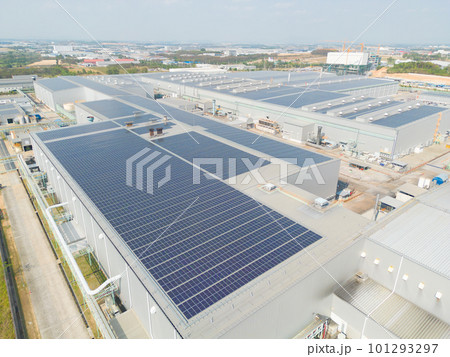 Aerial view of solar panels or solar cells on the roof of factory building rooftop. Power plant, renewable clean energy source. Eco technology for electric power in industry. Aerial view of solar panels or solar cells on the roof of factory building rooftop. Power plant, renewable clean energy source. Eco technology for electric power in industry. 101293297