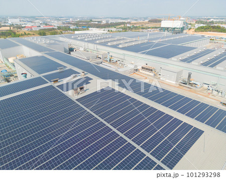 Aerial view of solar panels or solar cells on the roof of factory building rooftop. Power plant, renewable clean energy source. Eco technology for electric power in industry. 101293298