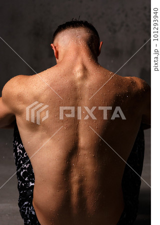 A guy in a great sports uniform in the studio on a gray background. 101293940