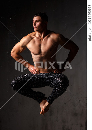 A guy in a great sports uniform in the studio on a gray background. 101293943