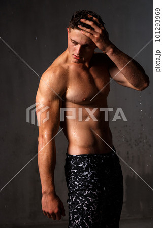 A guy in a great sports uniform in the studio on a gray background. 101293969