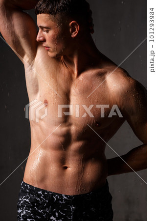 A guy in a great sports uniform in the studio on a gray background. 101293984