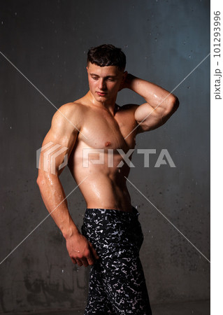 A guy in a great sports uniform in the studio on a gray background. 101293996