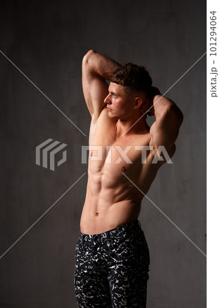 A guy in a great sports uniform in the studio on a gray background. A guy in a great sports uniform in the studio on a gray background. 101294064