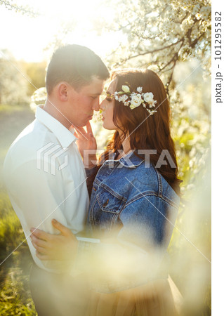 Beautiful loving couple in blooming gardens. Wedding concept. Great sunset light. Lovely newlyweds. Beautiful loving couple in blooming gardens. Wedding concept. Great sunset light. Lovely newlyweds. 101295582