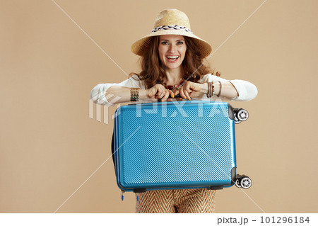 happy trendy woman in blouse and shorts isolated on beige 101296184