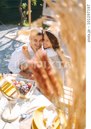 Beautiful wedding couple laugh and kiss relaxing in rv, camping in a trailer. Romantic moment. 101297197