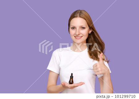 Skin care concept. Beauty portrait young woman holding pipette with cosmetic Skin care concept. Beauty portrait young woman holding pipette with cosmetic 101299710