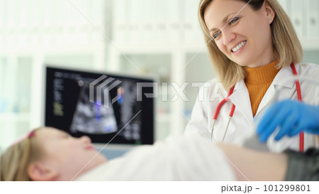 Doctor pediatrician conducting abdominal ultrasound examination of internal organs of child in clinic Doctor pediatrician conducting abdominal ultrasound examination of internal organs of child in clinic 101299801